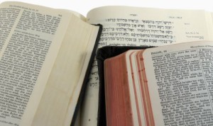 English (KJV), German, and Hebrew Bibles open to Isaiah 55, with clipping path